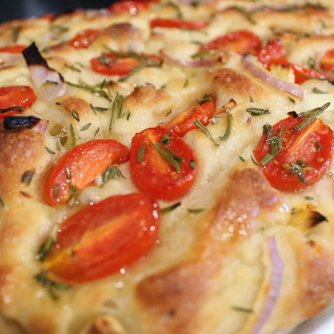 Focaccia topped with cherry tomatoes and rosemary